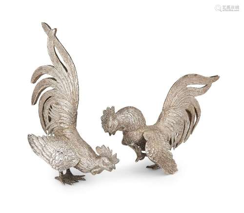 A pair of Continental silver fighting cockerels, with import...
