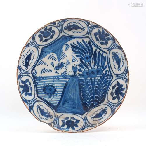 A tin glazed earthenware blue and white large dish, 18th cen...