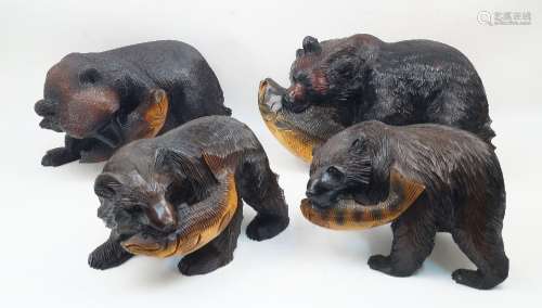 A group of four Japanese carved wood models of brown bears, ...