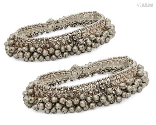 A pair of silver anklets, India, 20th century, composed of a...