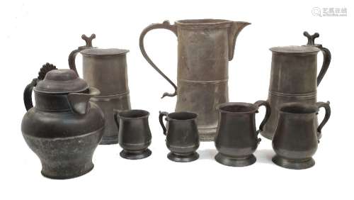 A collection of various pewter tankards, flagons and a jug, ...