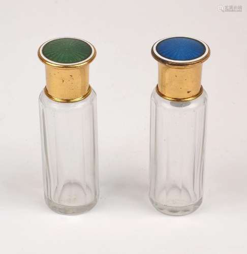 A cased pair of vanity bottles with enamelled gilt metal cap...