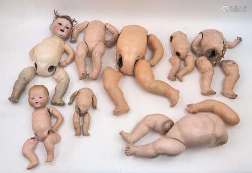 A doll restorer’s lot of various bent limb baby bodies, bisq...