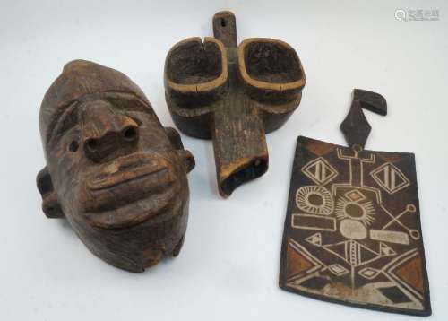 An African carved wooden mask, 36cm high, together with an A...