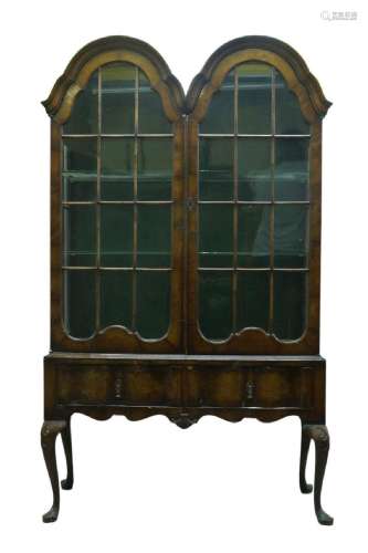 A Queen Anne style walnut twin arched display cabinet, early...