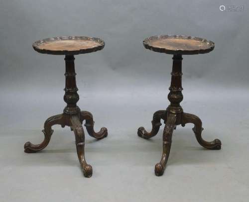 A pair of George II style mahogany tripod tables, early 20th...