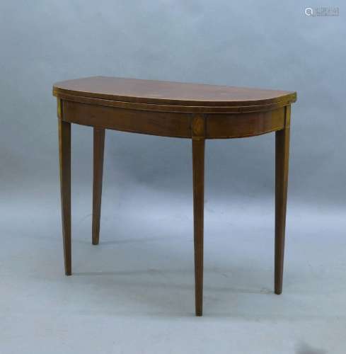 A George III mahogany fold over tea table, boxwood strung, w...