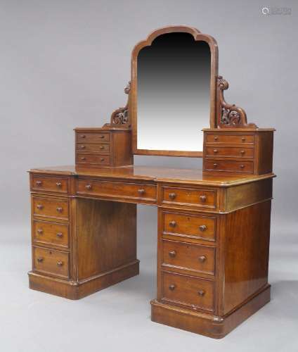 A Victorian mahogany dressing table, the swing mirror flanke...