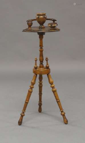 A Victorian walnut smokers stand, with pipe rack, three pots...