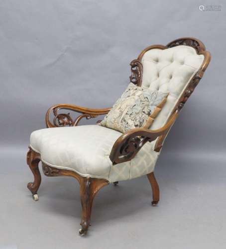 A Victorian walnut salon chair, with carved and pierced foli...