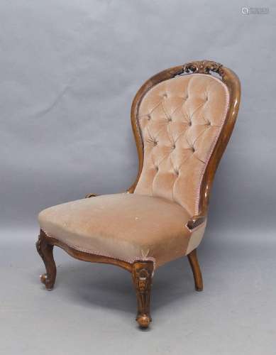 A Victorian walnut spoon back nursing chair, with velour but...