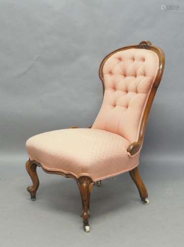 A Victorian walnut framed nursing chair, with pink button ba...