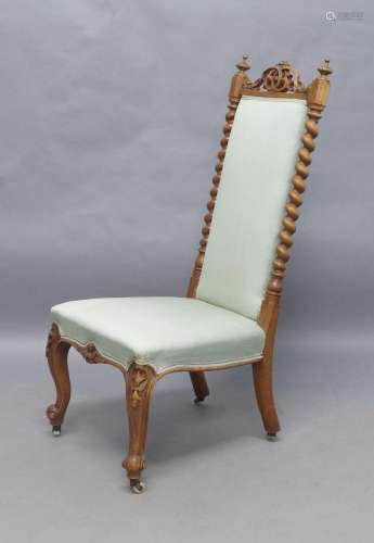 A Victorian walnut side chair, with carved and pierced crest...