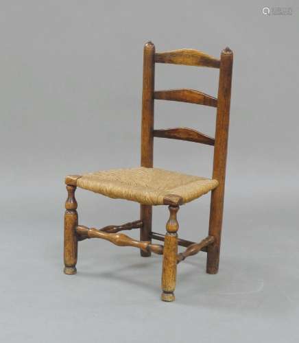 An elm child`s ladder-back chair, early 19th century, with a...
