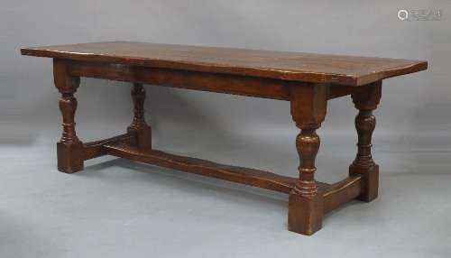 A oak refectory table, 19th century, the plank top raised on...