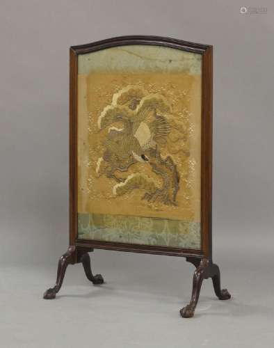 An Edwardian mahogany fire screen, inset with silk and silve...