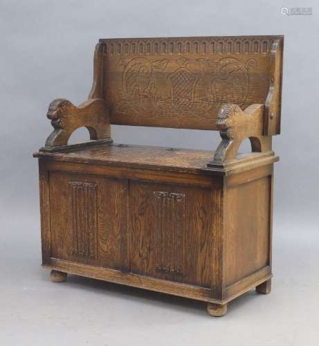 An oak monks bench, early 20th century, the folding top abov...