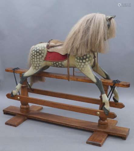 A hand painted carved wooden rocking horse, 20th century, wi...