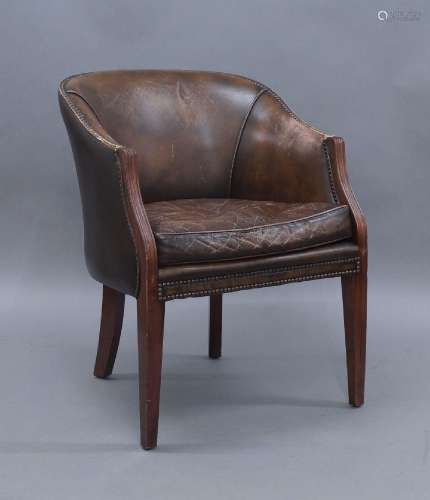 A set of three mahogany tub chairs, 20th century, with brown...