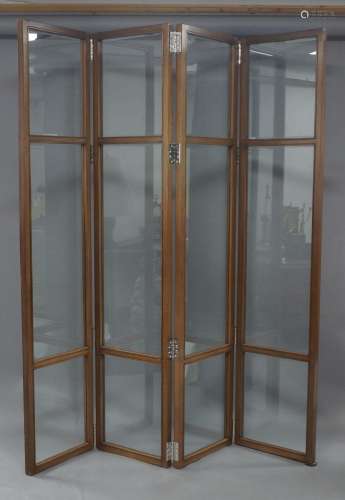 A glazed mahogany four fold screen, 21st century, with bevel...