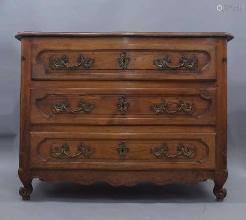 A French serpentine front walnut commode, 19th century, with...