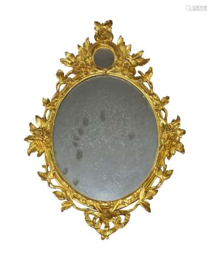 A George III carved giltwood oval wall mirror, with subsidia...