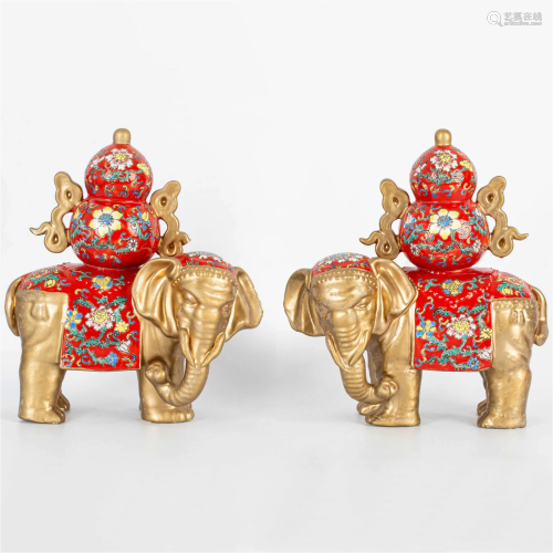 A pair of famille rose "Pingan" elephants, 20th ce...