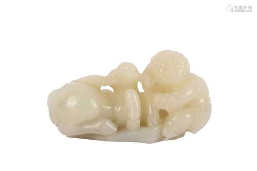 A CHINESE PALE CELADON 'BOY AND DEER' GROUP. Carved as a chi...