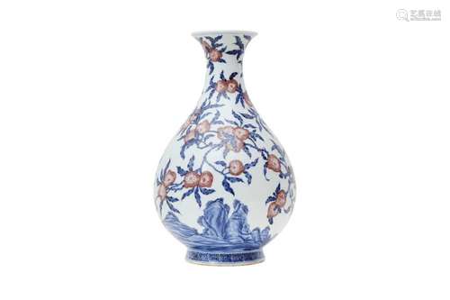 A CHINESE BLUE AND WHITE AND COPPER RED 'PEACHES' VASE