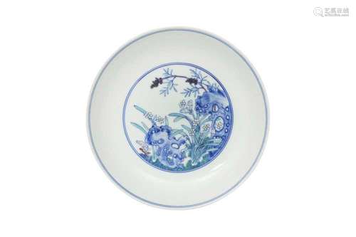 A CHINESE DOUCAI 'WILDFLOWERS' DISH. The centre painted with...