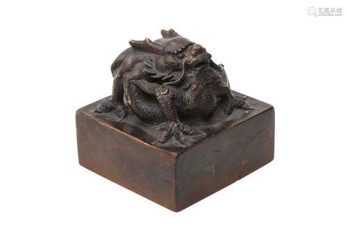 A CHINESE WOOD 'DRAGON' SEAL. The square-section face carved...