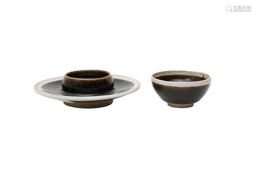 A CHINESE BLACK-GLAZED TEA BOWL AND STAND. The tea bowl with...