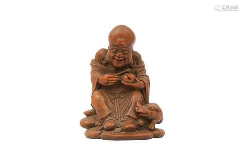 A CHINESE BAMBOO CARVING OF AN IMMORTAL. Worked in light col...