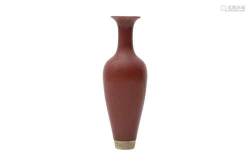 A CHINESE RED-GLAZED VASE. With a tapered body rising to a r...