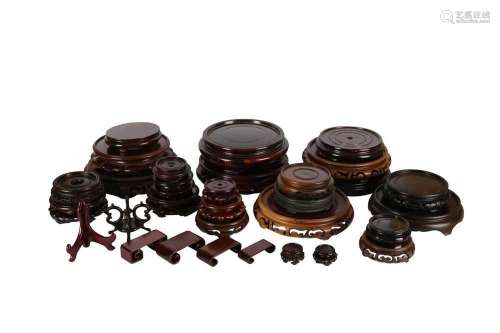A COLLECTION OF CHINESE WOOD STANDS. Comprising a small plat...