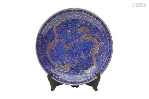 A CHINESE BLUE-GROUND GILT-DECORATED 'DRAGON' DISH