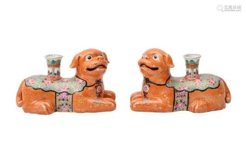 A PAIR OF CHINESE FAMILLE ROSE 'DOG' CANDLE HOLDERS