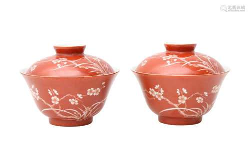 A PAIR OF CHINESE CORAL-GROUND 'PRUNUS' BOWLS AND COVERS