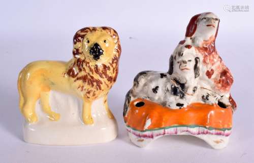 TWO 19TH CENTURY STAFFORDSHIRE FIGURES depicting a lion and ...