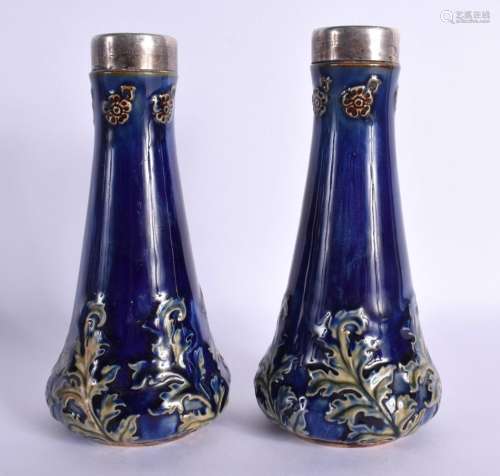 A PAIR OF ANTIQUE SILVER MOUNTED ROYAL DOULTON VASES. 16.5 c...