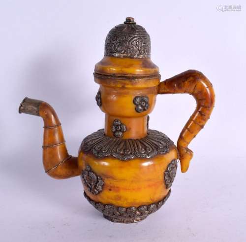 AN EARLY 20TH CENTURY SINO TIBETAN AMBER AND WHITE METAL EWE...