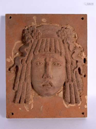A 1930S CARVED WOOD PLAQUE modelled as masked female. 27 cm ...