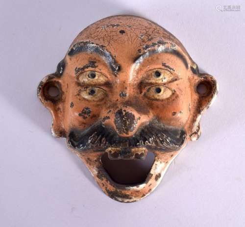 A VINTAGE PAINTED IRON MASK BOTTLE OPENER. 8.25 cm wide.