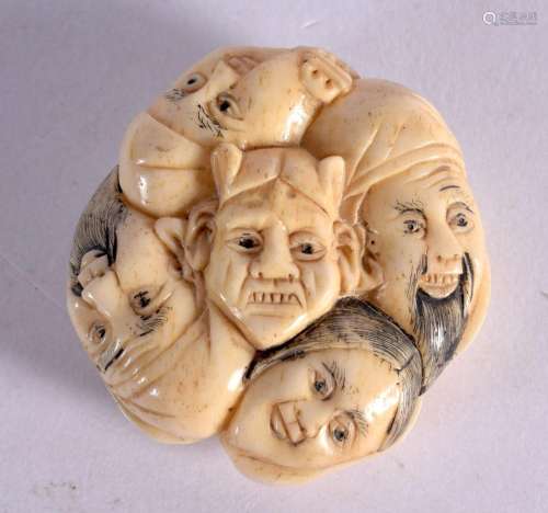 A JAPANESE CARVED BONE MASK HEAD NETSUKE. 3.75 cm wide.