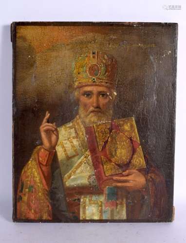 AN ANTIQUE RUSSIAN PAINTED WOOD ICON. 28 cm x 21 cm.