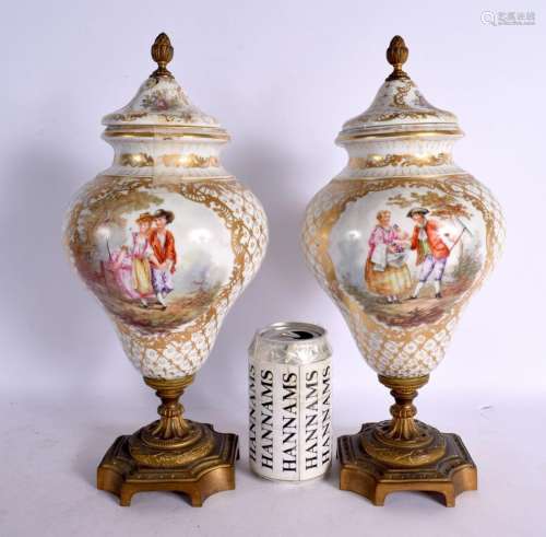 A PAIR OF EARLY 20TH CENTURY GERMAN PORCELAIN URNS AND COVER...