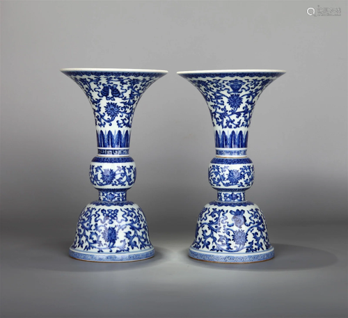 A PAIR OF BLUE AND WHITE EIGHT TREASURED PATTER BEAKER VASES