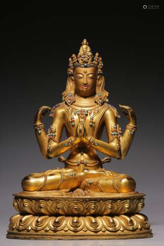 Sitting statue of Guanyin with four arms inlaid with gold an...