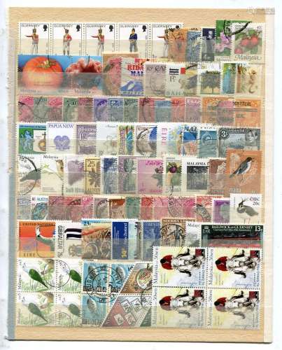 A collection of world stamps in a stock book and on stock pa...