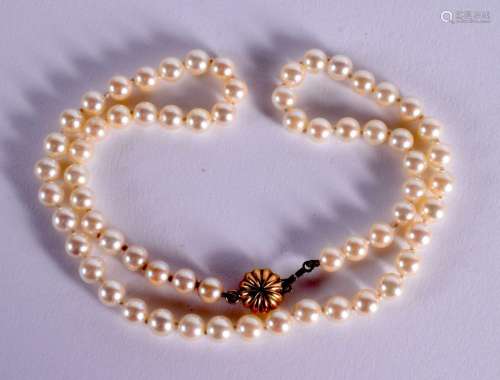 A CULTURED PEARL NECKLACE WITH 9CT GOLD MOUNTS. Stamped 375,...